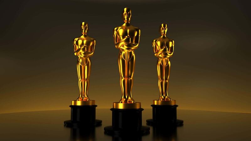 A photo of three Academy Award statuettes