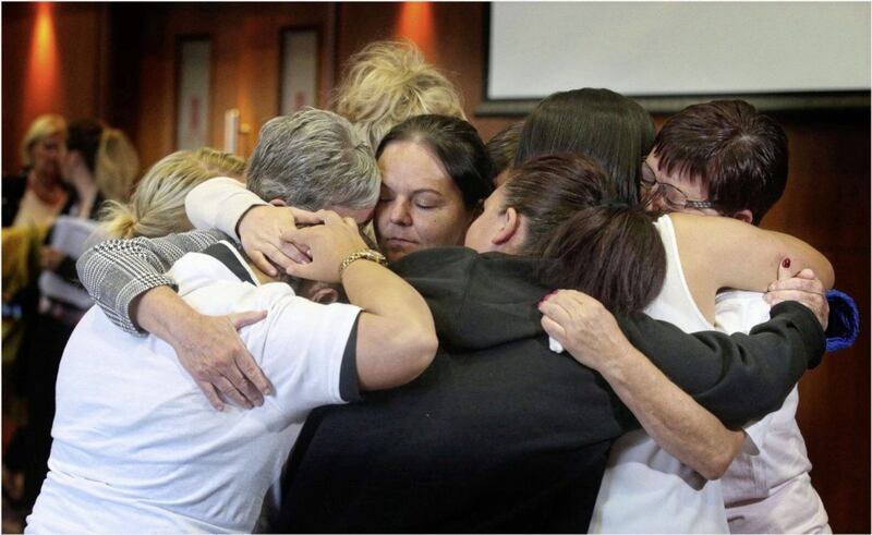 Families of relatives at Dunmurry Manor embrace after the shocking findings of a report into care failings was published in June. Picture by Hugh Russell