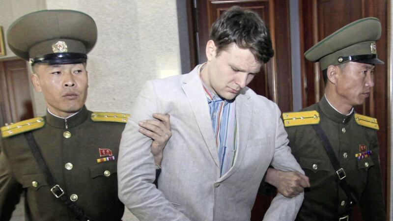 US student Otto Warmbier, center, is escorted at the Supreme Court in Pyongyang, North Korea, last year. Mr Warmbier died Monday Picture: AP 