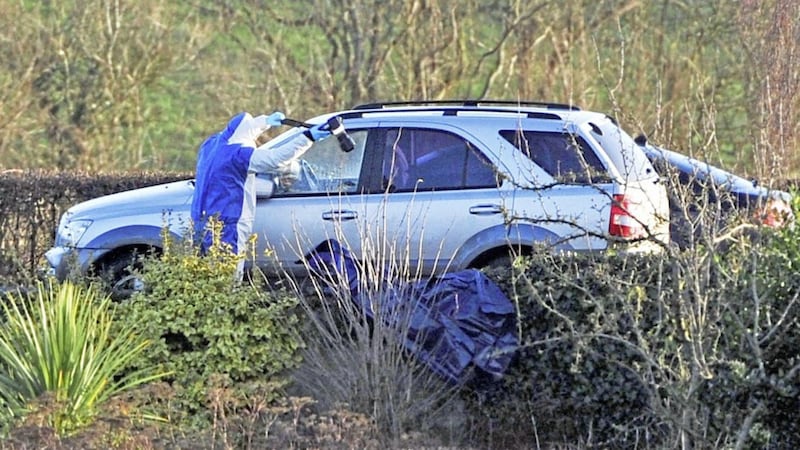 Police forensic experts examine a car involved in the murder of Nelson Cheung 