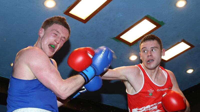 Daniel Anderson takes a hit from Gerard French during Monday night's Ulster Elite Championship bout at the Dockworkers' club, Belfast.&nbsp;Pictures by Hugh Russell&nbsp;