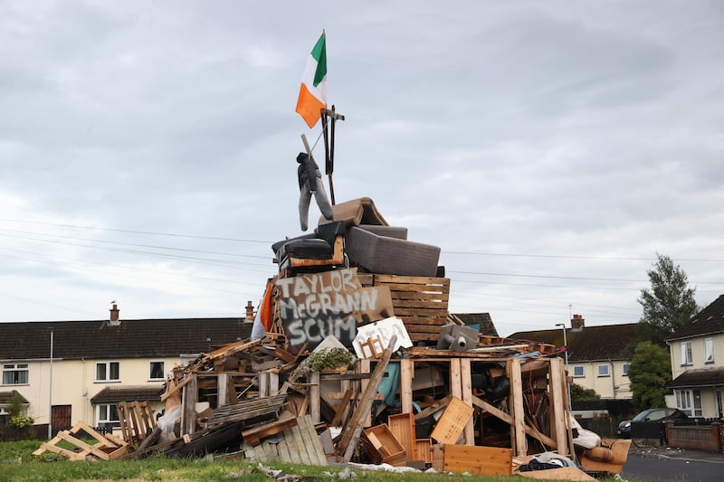 An effigy above a poster with the name of Taylor McGrann, the Sinn Fein Councillor for Antrim & Newtownabbey Borough, on the bonfire at Carnreagh Bend, Rathcoole, Newtownabbey