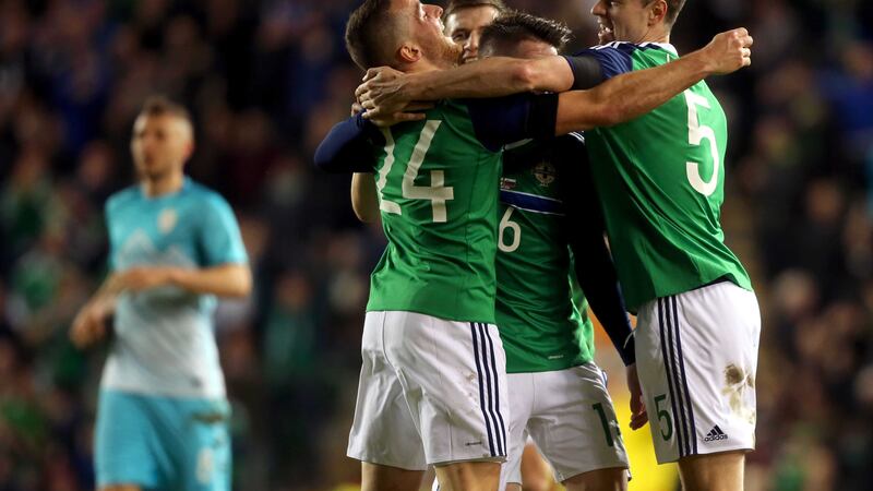 Northern Ireland's Conor Washington (left) celebrates his goal with his team-mates during Monday's friendly at Windsor Park<br />Picture by PA&nbsp;