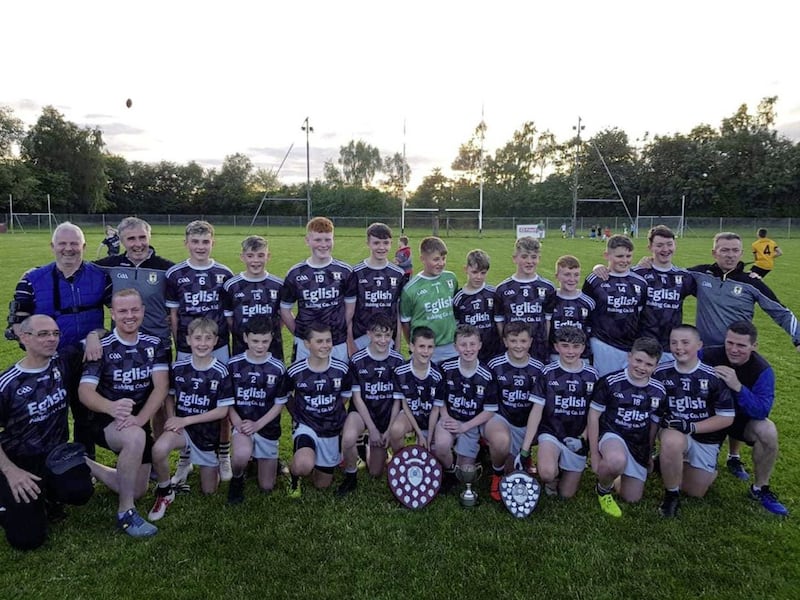 Eglish St Patrick&#39;s U14 team and management pictured with all three titles. 