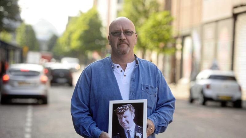 Sam McLarnon holds a picture of his father Samuel who was shot dead by the RUC in August 1969. Picture by Mark Marlow 