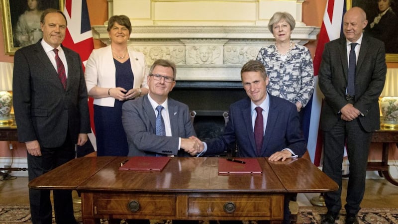 Sir Jeffrey Donaldson (seated on left) at the signing of the confidence and supply deal in June. Picture by Daniel Leal-Olivas/PA Wire 