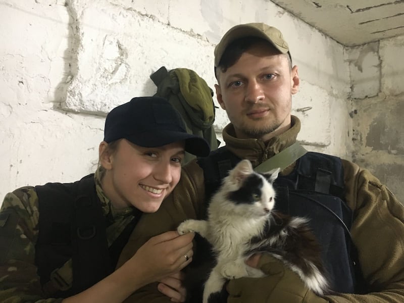 Oskana Krasnova, 27, and her husband Stanislav Krasnov, 35, holding a rescued cat. 