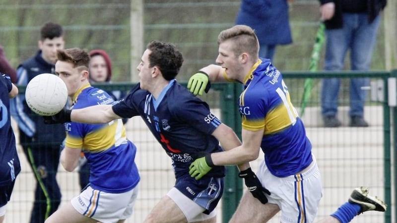 St Ciaran&#39;s Tomas Hoy struggling to gain control of the ball due to the pressure from St Louis&#39; Conor Kinsella 