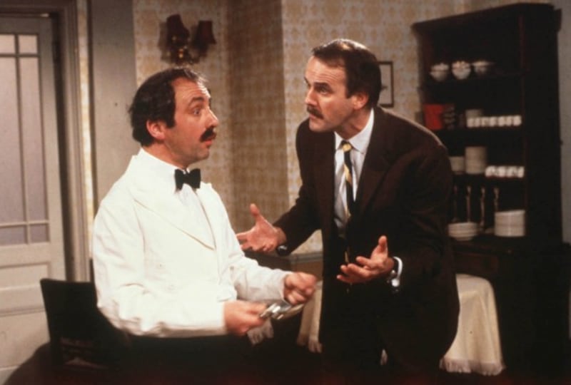 John Cleese as Basil Fawlty with Andrew Sachs as Manuel in Fawlty Towers (BBC/PA)