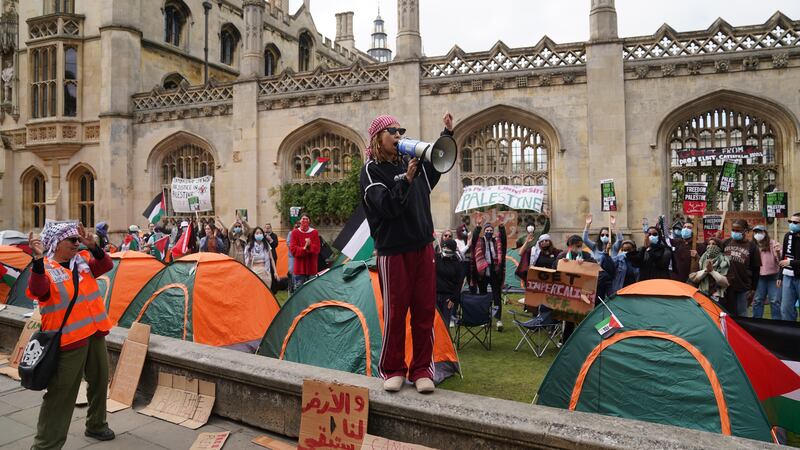 Students speaking at an encampment on the grounds of Cambridge University