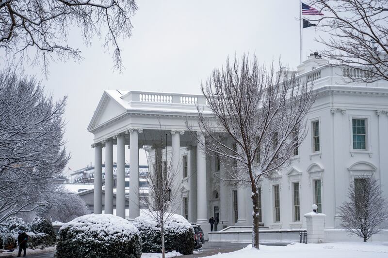 A worker removes snow from the White House driveway in Washington, DC (AP)