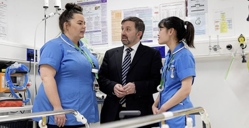 Health minister Robin Swann with staff nurses Amber Loung (right) and Gillian Browne during a visit to the Emergency Department of the Ulster Hospital in Dundonald, Northern Ireland. Picture by Michael Cooper. 