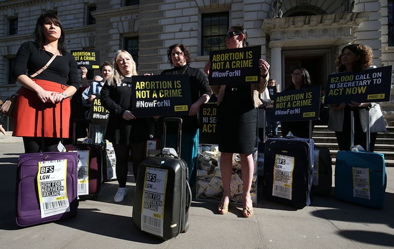 Derry Girls cast members Siobhan McSweeney (centre) and Nicola Coughlan (second left) join women impacted by Northern Ireland's strict abortion laws who are carrying suitcases, symbolising the women who travel from Northern Ireland to Great Britain for terminations, across Westminster Bridge demanding legislative change&nbsp;