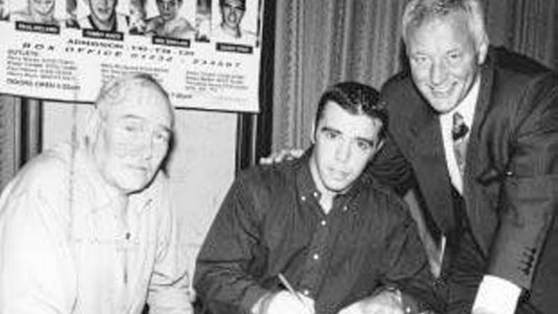 ON BOARD... Glenn McLarnon (centre) signs up for the Matchroom stable watched by coach Gerry Storey (left) and a happy Barry Hearn  