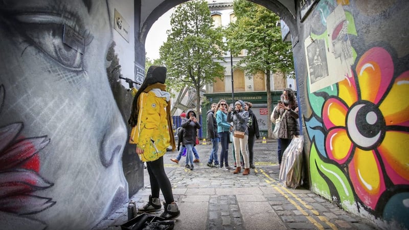 Artists paint a mural in Exchange Place off Donegall Street, Belfast as part of the Culture Night celebrations. Picture by Mal McCann 