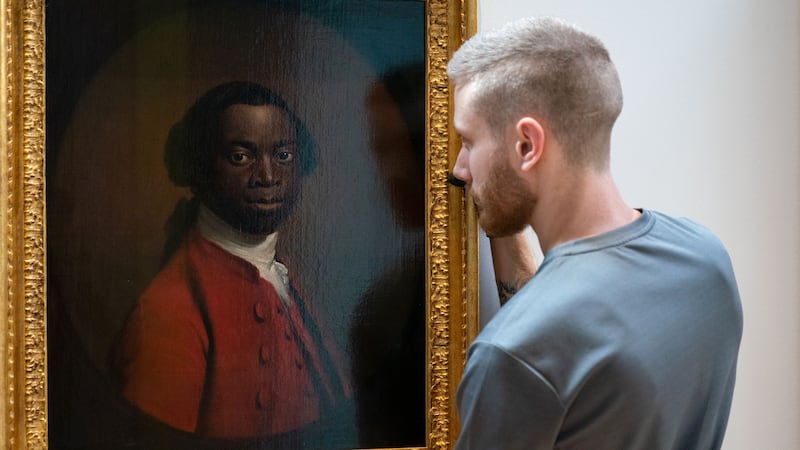 Portrait Of A Man In A Red Suit, c.1740-80, is hung during a photo call to mark the opening of Cambridge’s Fitzwilliam Museum’s new Black Atlantic: Power, People, Resistance exhibition (Joe Giddens/PA)