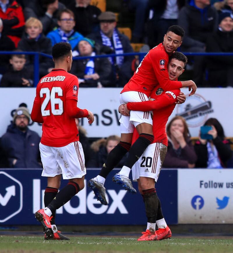Manchester United's Jesse Lingard (centre) celebrates scoring his side's third goal of the game with team mates Diogo Dalot (right) and Mason Greenwood during the FA Cup fourth round match against Tranmere Rovers at Prenton Park, Birkenhead on Sunday January 26, 2020. Picture by&nbsp;Simon Cooper/PA Wire.&nbsp;