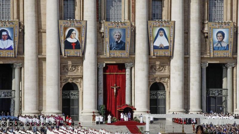 Tapestries hanging from the facade of St. Peter&#39;s Basilica portray the new saints from left, Dulce Lopes Pontes, Giuseppina Vannini, John Henry Newman, Maria Teresa Chiramel Mankidiyan, and Margarita Bays, at the Vatican. Picture by AP Photo/Alessandra Tarantino 