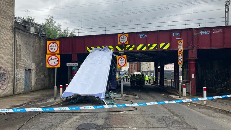 An investigation is under way after a double-decker bus hit a railway bridge and had its roof sheared off, leaving 10 people needing hospital treatment (Network Rail/PA)