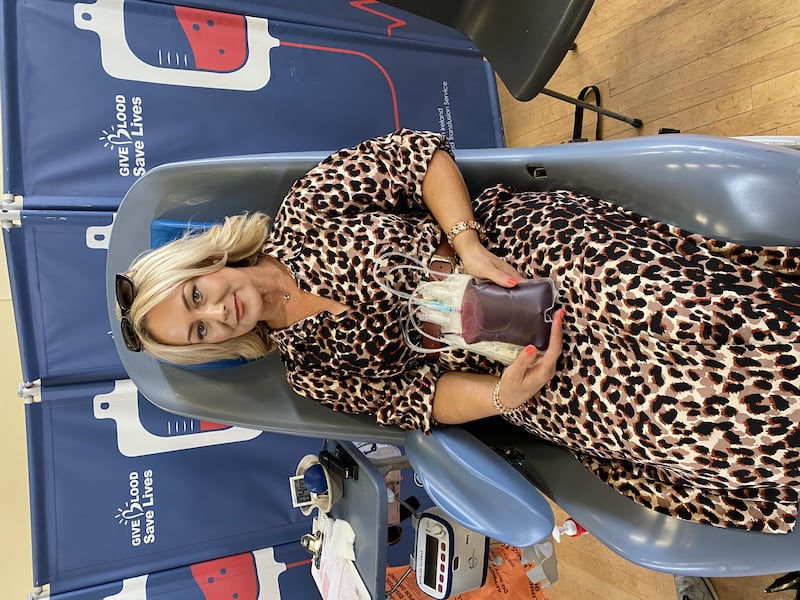 Holly Gormley's mum Claire with a blood donation bag at a donor event.