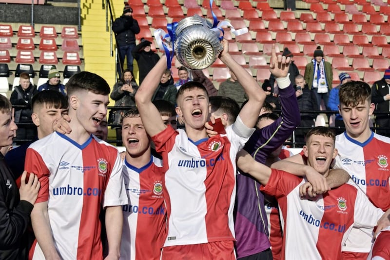 Linfield Swifts Trai Hume lifts the trophy in 2019, beating Newington 3-1 