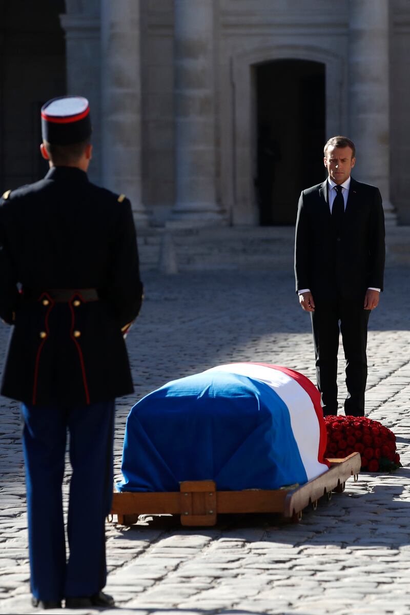 Emmanuel Macron stands in front of the coffin of Charles Aznavour