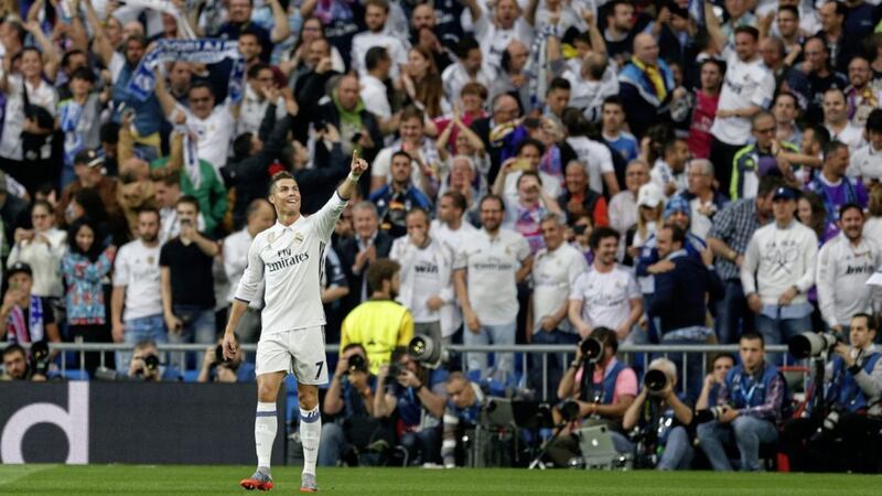 Real Madrid&#39;s Cristiano Ronaldo celebrates scoring the opening goal during the Champions League semi-final first leg against Atletico Madrid at the Santiago Bernabeu stadium in Madrid 