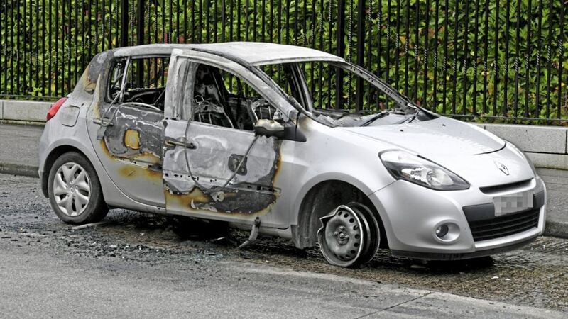 A Renault Clio was set on fire at Beechmount Avenue in west Belfast following a hijacking in the south of the city on Saturday. Picture by Alan Lewis, Photopress 