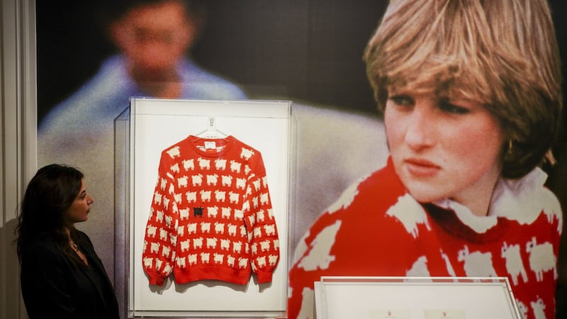 Nezha Bernoussi, marketing and communication associate at Sotheby’s looks at the late Diana, Princess of Wales’ black sheep jumper on display at Sotheby’s, central London, ahead of its sale as part of the auction house’s inaugural Fashion Icons sale in New York in September. The jumper, which she wore on several occasions, is estimated to sell for $50,000-$80,000 (�40,000-�70,000 pounds sterling), with online bidding open from August 31 to September 14. Picture date: Monday July 17, 2023.
