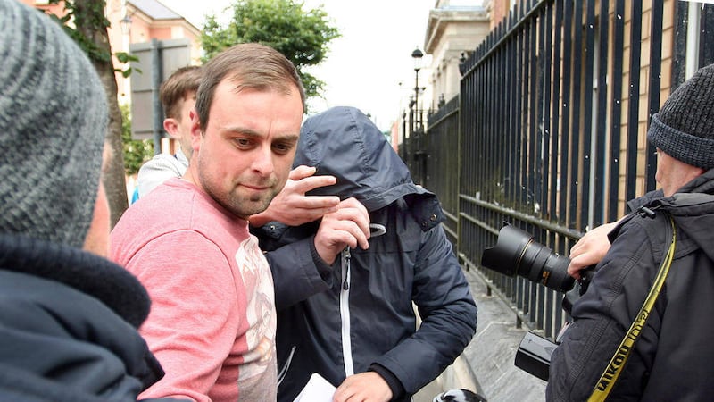 John McClements, formerly known as Daryl Proctor, in navy hood, is helped back into the Fountain Estate, situated beside Derry Courthouse after being granted bail. Appearing at Derry Court on Saturday charged with the murder of Paul McCauley. Paul died last month after being left with brain damage following an attack by McClements/Proctor and a loyalist gang while Paul was attending a barbque with friends nine years ago in the Waterside area of Derry. Picture Margaret McLaughlin &Acirc;&copy; please by-line 18-7-15 see court story. 