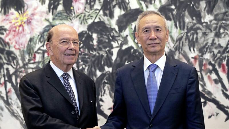 US commerce secretary Wilbur Ross, left, shakes hands with Chinese Vice Premier Liu He as they pose for photographers after their meeting at the Diaoyutai State Guesthouse in Beijing, on Sunday. Picture by Andy Wong, Pool, Associated Press 
