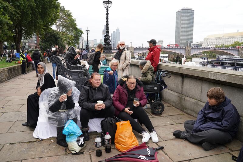 Members of the public join the queue on the South Bank, as they wait to view the coffin of Queen Elizabeth II lying in state ahead of her funeral on Monday
