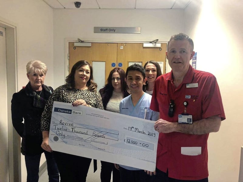 Sharon Lyttle presents a &pound;12,000 cheque to the Royal Victoria Hospital's intensive-care unit in her son Niall&rsquo;s memory