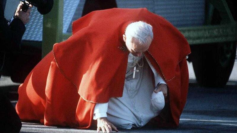 Pope John Paul II as he kisses the ground on arrival in Dublin during his visit to Ireland in 1979 