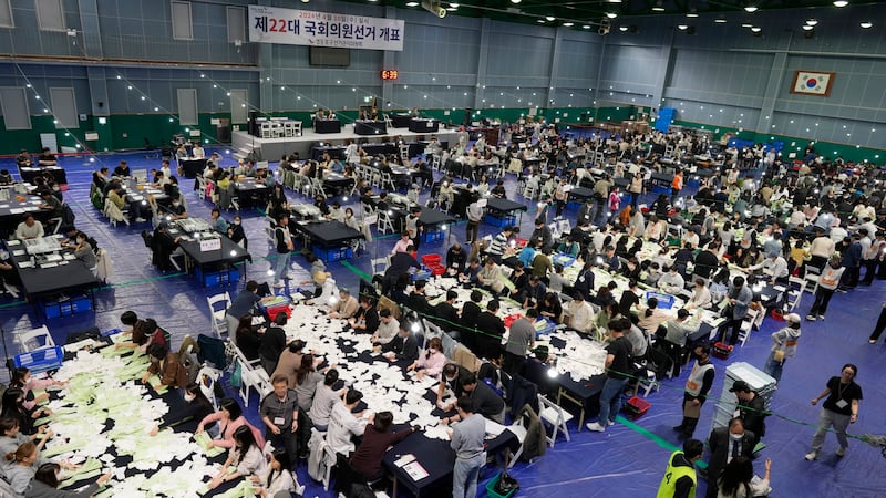 National Election Commission officials sort ballots for counting at the parliamentary election in Seoul (Lee Jin-man/AP)