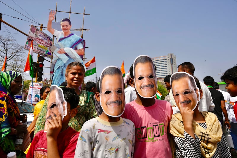 Supporters of the Aam Admi Party wore masks in the likeness of party leader Arvind Kejriwal at the rally (Manish Swarup/AP)