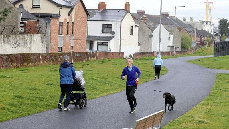 Avid runner Simon Doyle exercises in east Belfast with trusty companion Chester. Picture by Mal McCann 