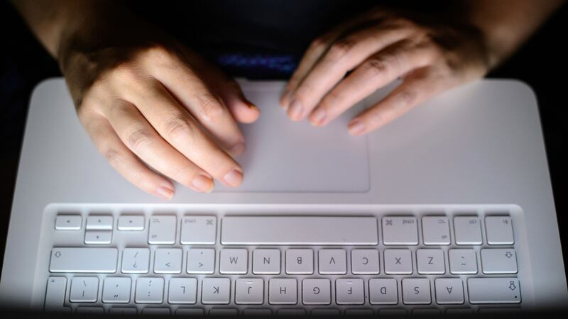 A woman’s hands using a laptop keyboard (Dominic Lipinski/PA)