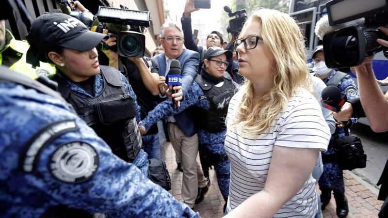 Cassandra &quot;Cassie&quot; Sainsbury is escorted by police to a court hearing in Bogota, Colombia PICTURE: Fernando Vergara/AP 