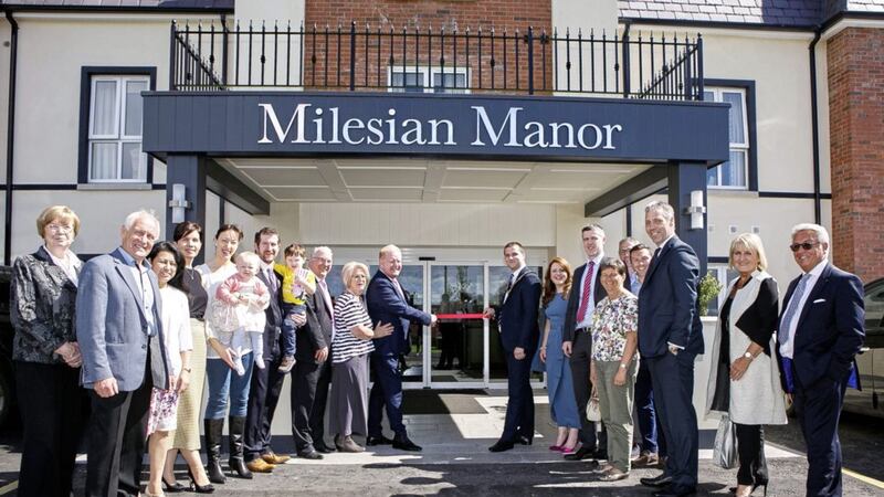 The Macklin family are pictured with TV personality, Julian Simmons and Mark Glasgow from the Mid Ulster Council alongside staff, friends and family from Milesian Manor. 