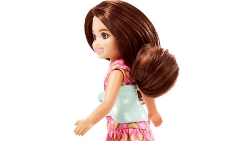 Mattel’s new 6in Chelsea figure wears a pink dress and has a removable back brace.