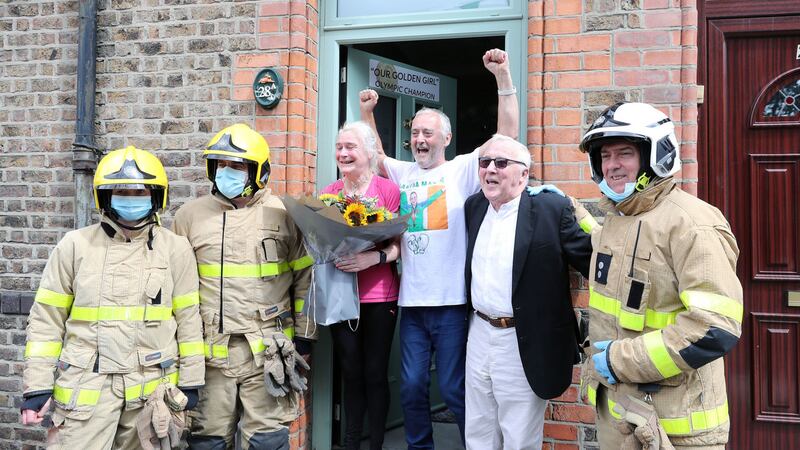 Kellie Harrington's parents Yvonne and Christy Harrington, are presented with flowers by Dublin Fire fighters as they are visited by local councillor Christy Burke outside the family home in Dublin, after Kellie won the gold medal in the Tokyo Olympics. Picture by Niall Carson/PA Wire&nbsp;