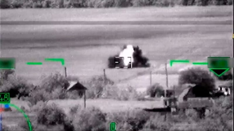 In this image from video, released by the Russian Defense Ministry Press Service on June 6, 2023, shows what Russia claimed was the destruction of a German-made Leopard tank. But a visual analysis by The Associated Press shows the grainy black-and-white video Russia released prove it had blown up the tanks actually documented the destruction of a tractor. Two experts, who watched the Russian video, both said the vehicle struck by the helicopter’s missile was not a Leopard tank, or any other type of armored vehicle. Valentin Châtelet, a research associate at The Atlantic Council’s Digital Forensic Research Lab, also said the objects in the video were clearly not Leopard tanks.(Russian Defense Ministry Press Service via AP)
