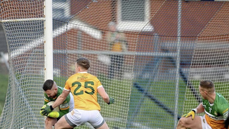 Offaly goalkeeper Ian Duffy prevents Antrim substitute Odhran Eastwood scoring a late goal at Corrigan Park. Pic: Mark Marlow 