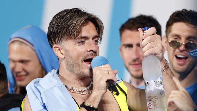 Manchester City’s Jack Grealish with a bottle of vodka on stage (Will Matthews/PA)