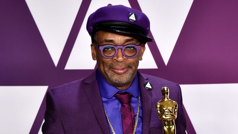 The BlacKkKlansman director is wearing a purple and gold suit featuring the basketball player’s number.