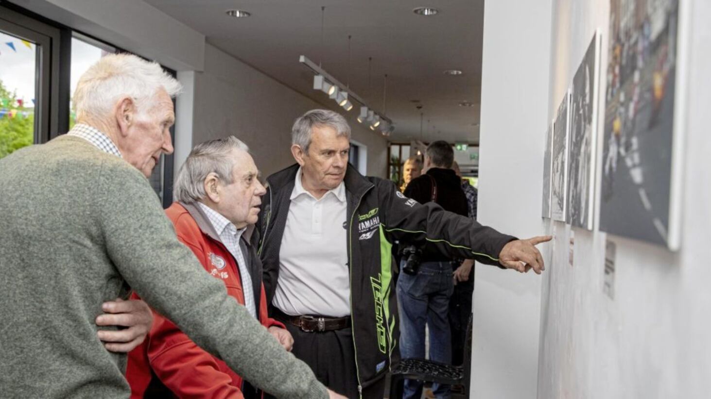 Famous past NW200 racers, two-time winner Dick Creith (left) and Len Ireland (centre) at the photographic exhibition at Roe Valley Arts and Cultural Centre, which features images taken from the book the &lsquo;NW200 90th Road &amp; Race&rsquo;, by Ian Foster. Picture by McAuley Multimedia 