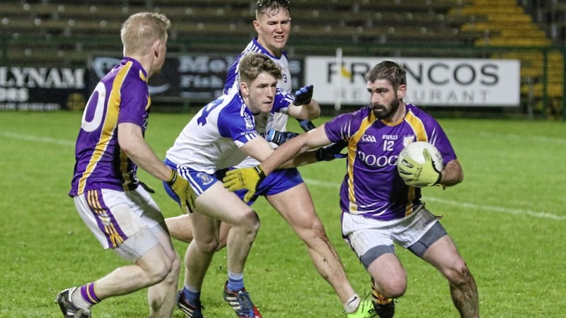 Derrygonnelly forward Declan Cassidy holds off Armagh duo Ultan Lennon and Conor White as colleague Aidan Gallagher moves to support him Picture by Jason Moncrieff. 