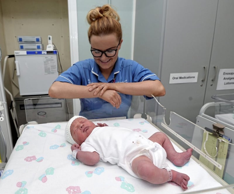 Baby McCaughran with midwife Louise Ui Eachain who was born at 1.14am at the Royal Victoria Hospital in Belfast. Picture by Colm Lenaghan/Pacemaker 