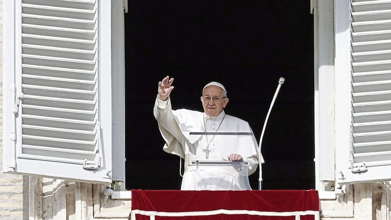 Pope Francis waves to faithful during the Angelus noon prayer he delivered from his studio window overlooking St Peter&#39;s Square at the Vatican, yesterday. Picture by Andrew Medichini, Associated Press 